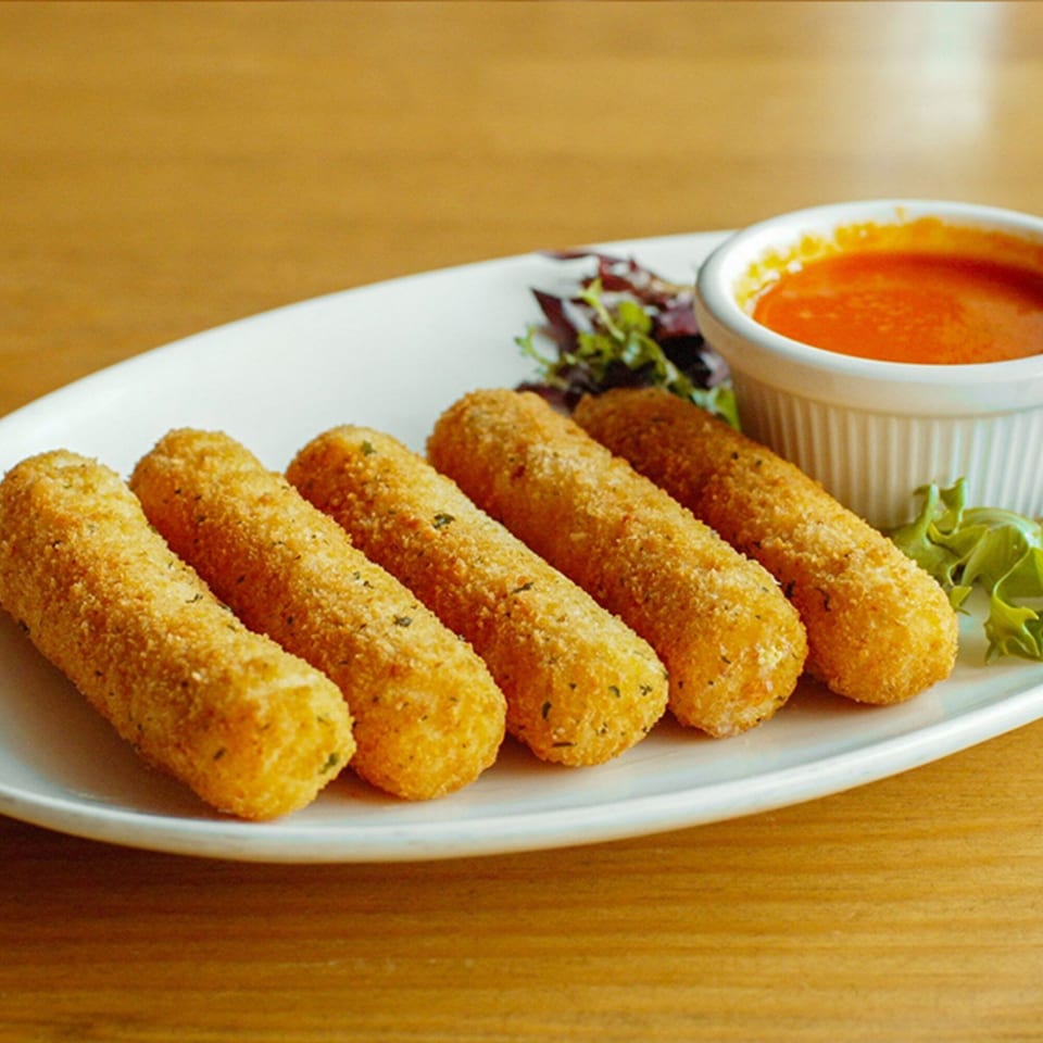 Five golden-brown mozzarella sticks with a side of red dipping sauce and a small salad garnish.