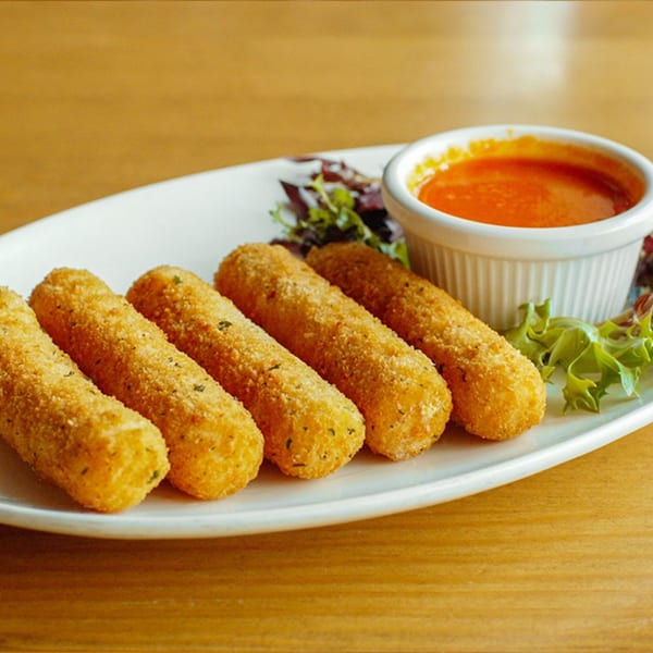 Five golden-brown mozzarella sticks with herbs, served with a side of red sauce and green salad.